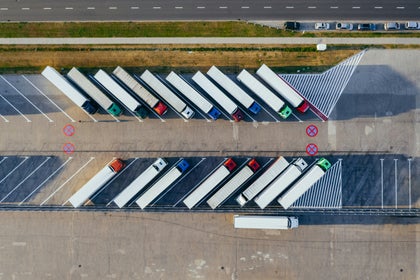 A group of tractor trailers parked