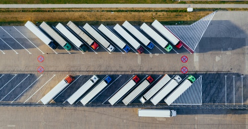 A group of tractor trailers parked A group of tractor trailers parked