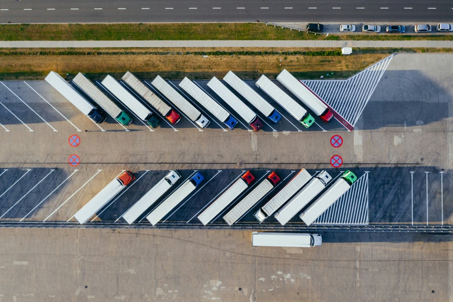 A group of tractor trailers parked