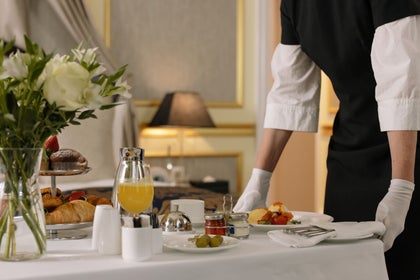 a server setting a table setting at a restaurant 