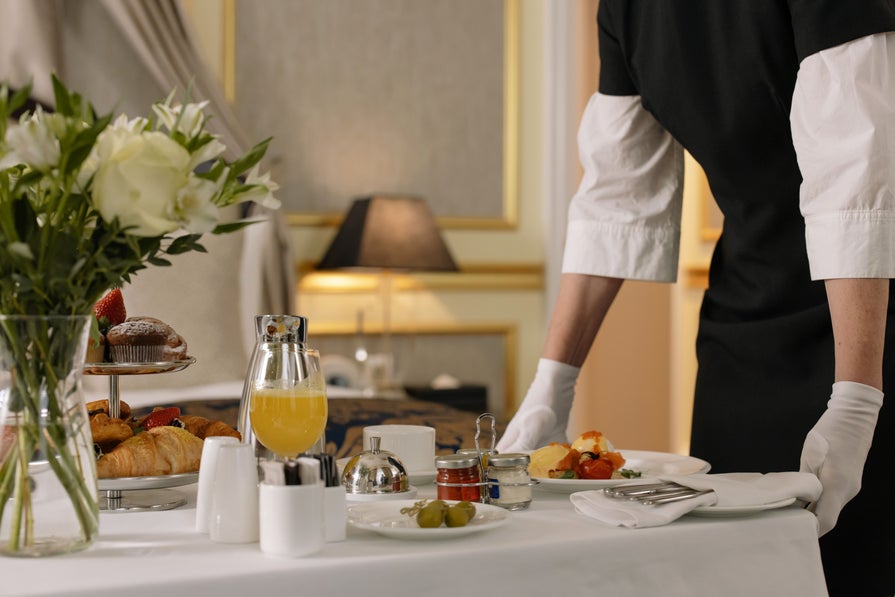 a server setting a table setting at a restaurant 