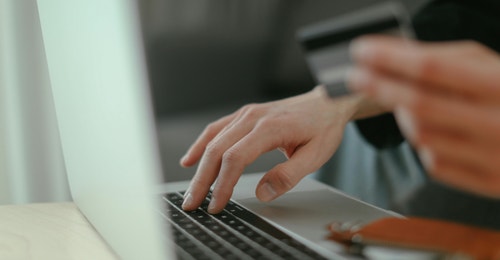 Using a credit card to purchase something on a laptop Using a credit card to purchase something on a laptop