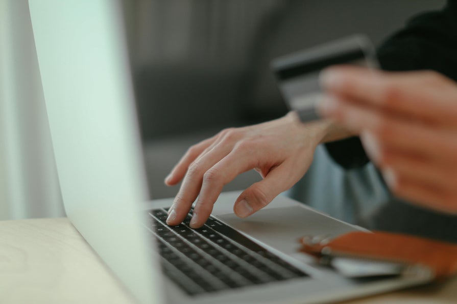 Using a credit card to purchase something on a laptop