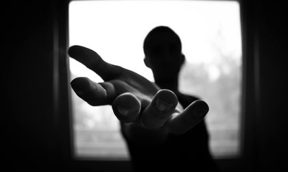 Black and white image of a hand reaching out