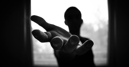 Black and white image of a hand reaching out Black and white image of a hand reaching out