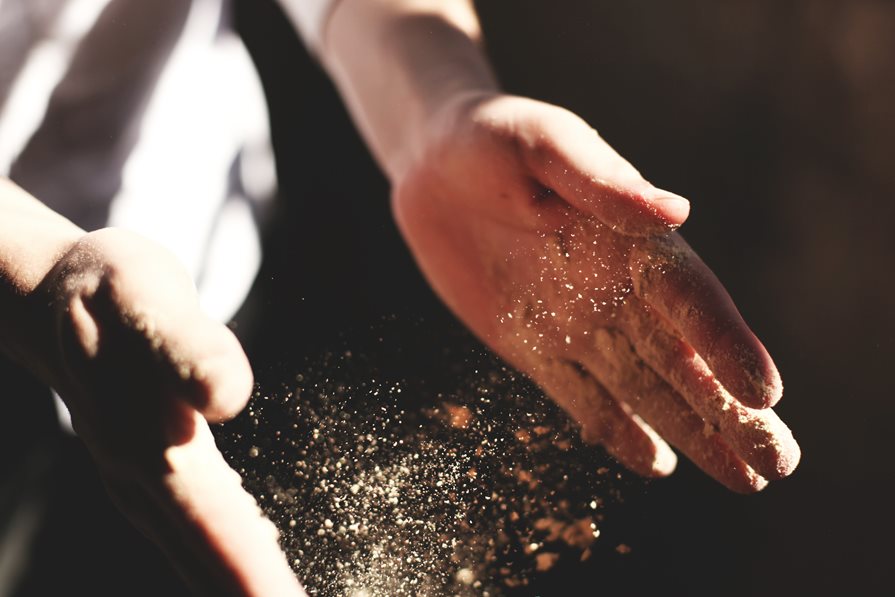 A pair of hands with particles in between