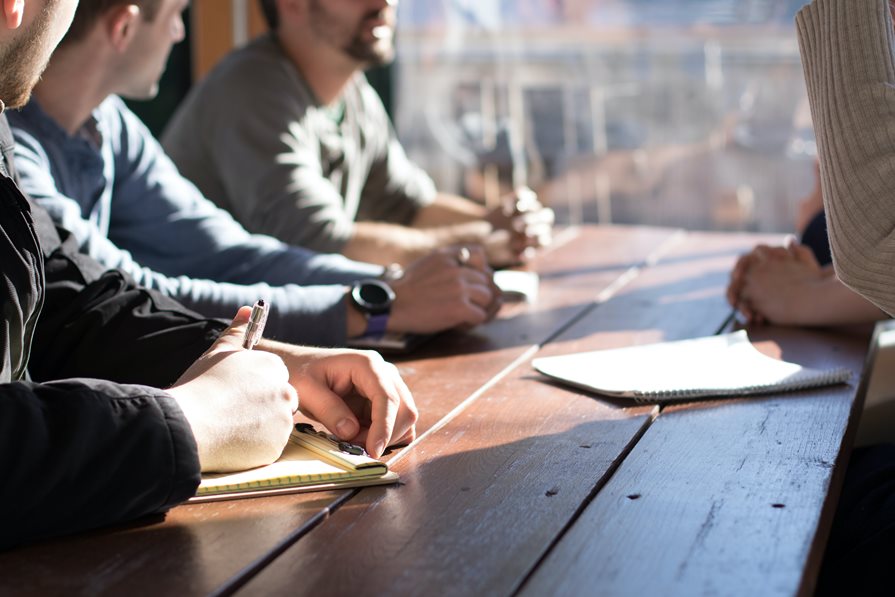 A group of people writing notes on paper