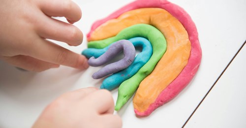 Playdough in the shape of a rainbow