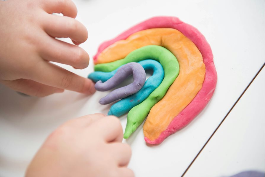 Playdough in the shape of a rainbow