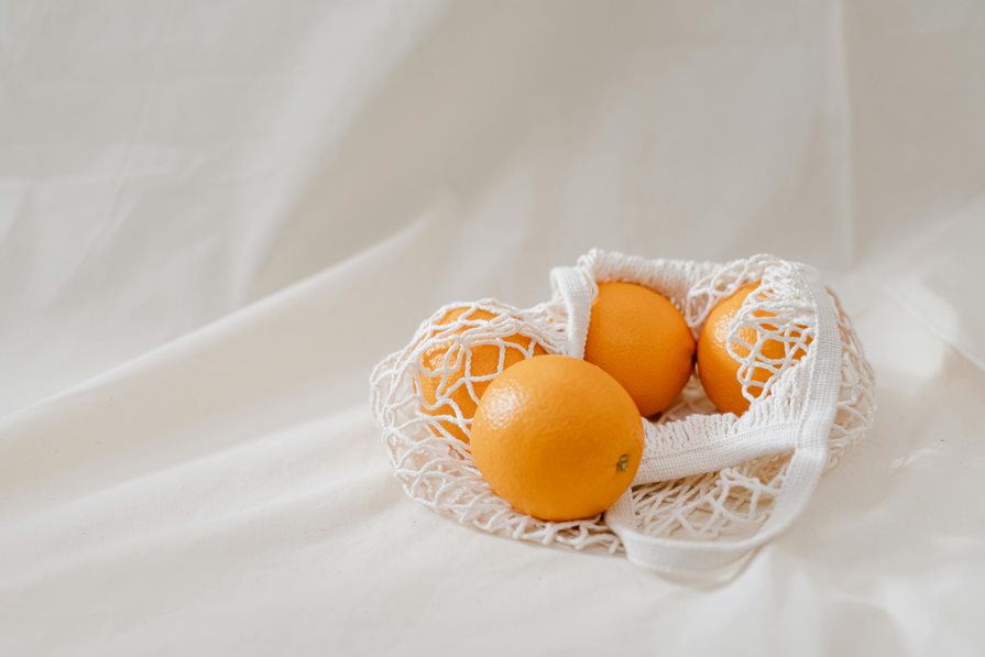 Oranges placed in a reusable produce bag