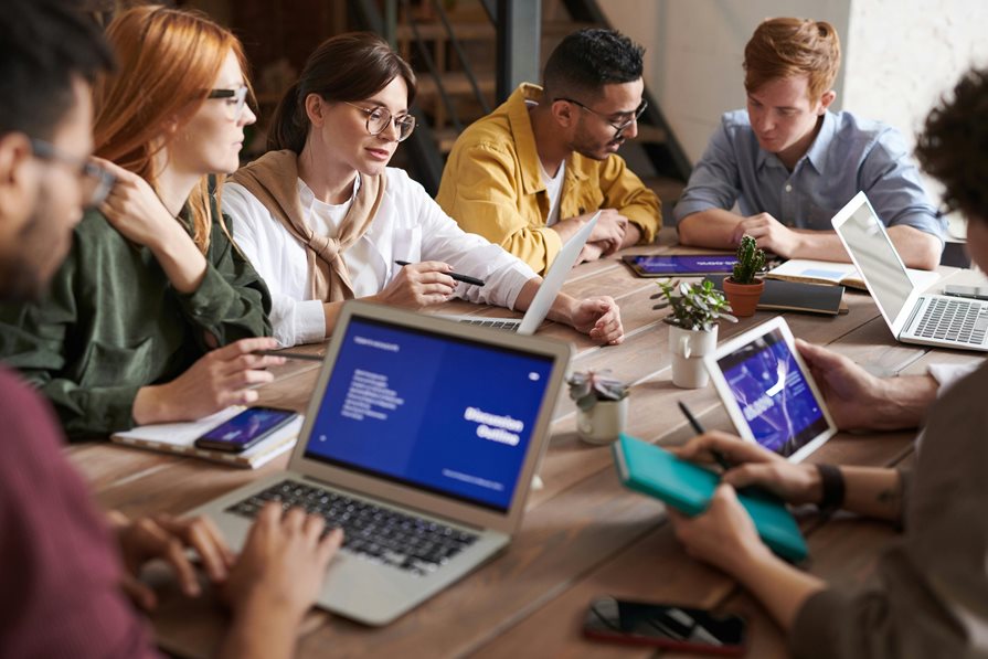 A group sits at a conference room table together