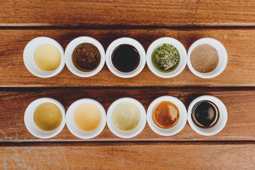  A row of sauces in cups