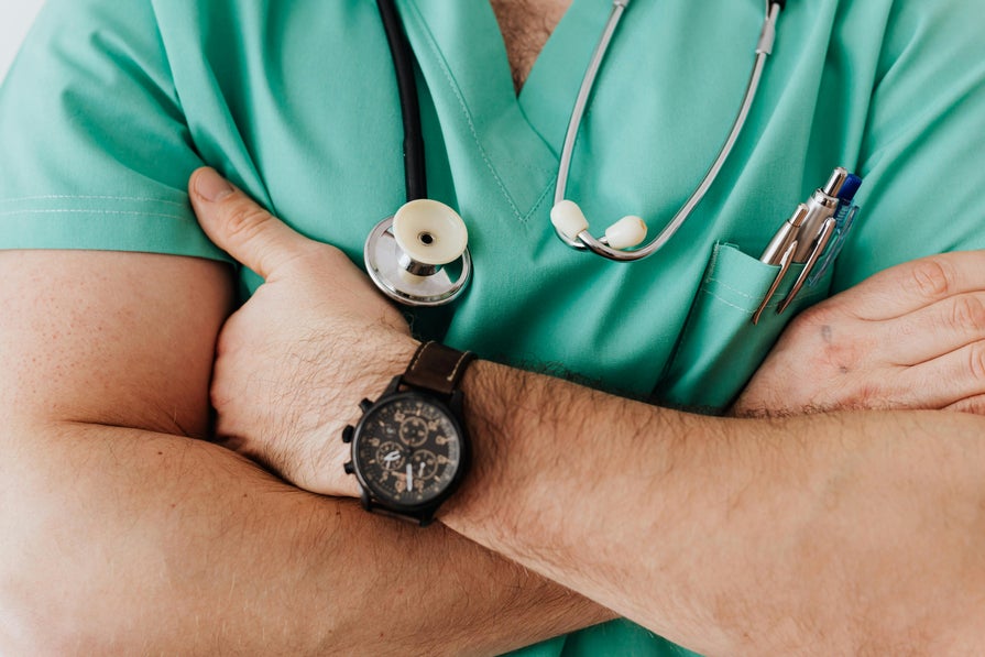 A doctor crosses his arms A doctor crosses his arms