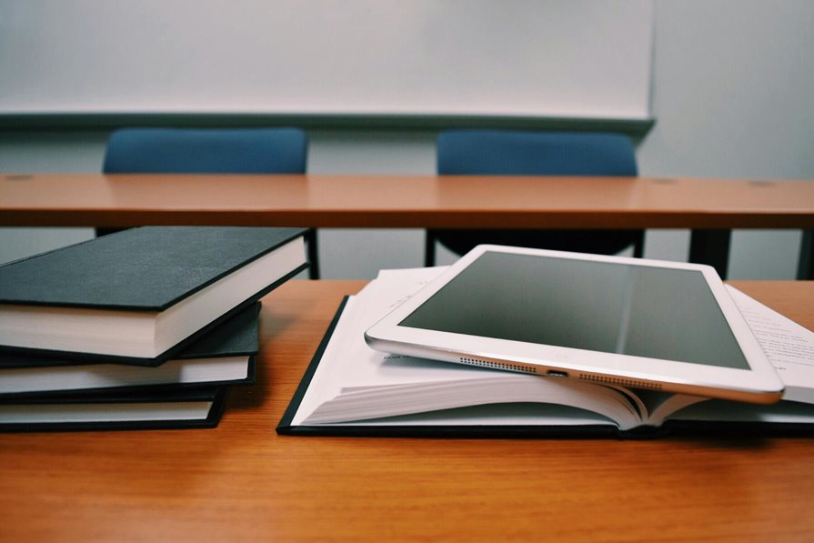 A stack of books on a classroom desk