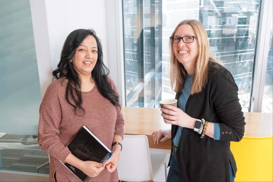 Two eHealth employees smiling at camera