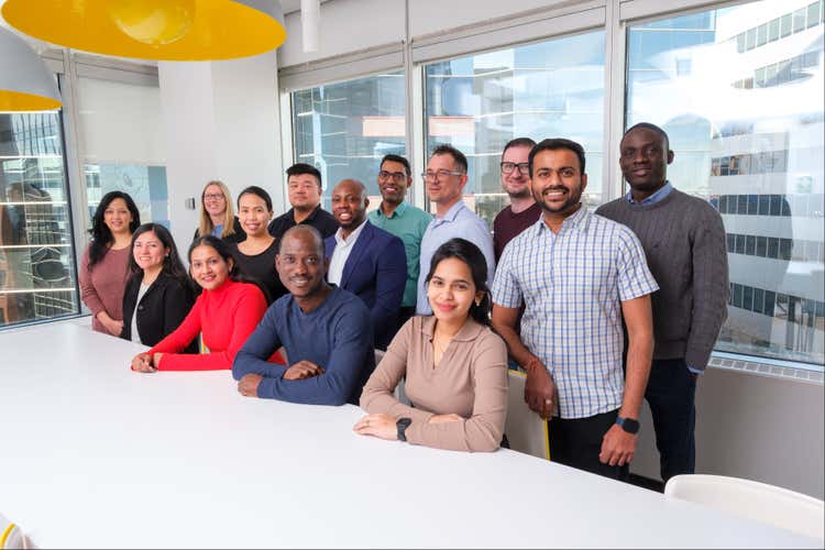 A group of employees in an office's common area.