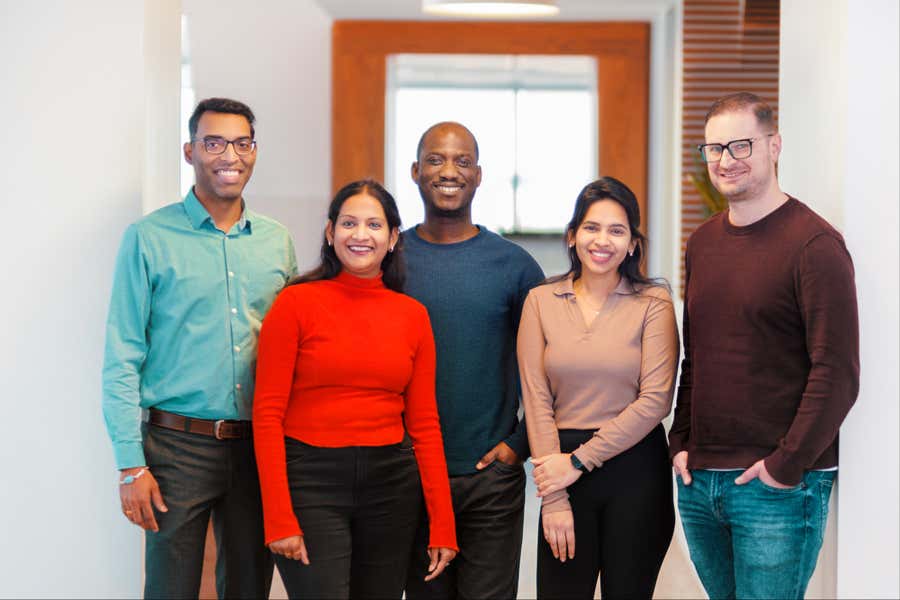 eHealth employees smiling at the camera.