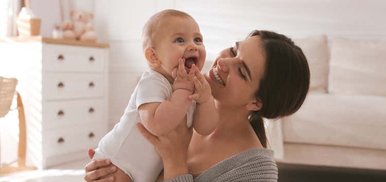 Woman holding baby.
