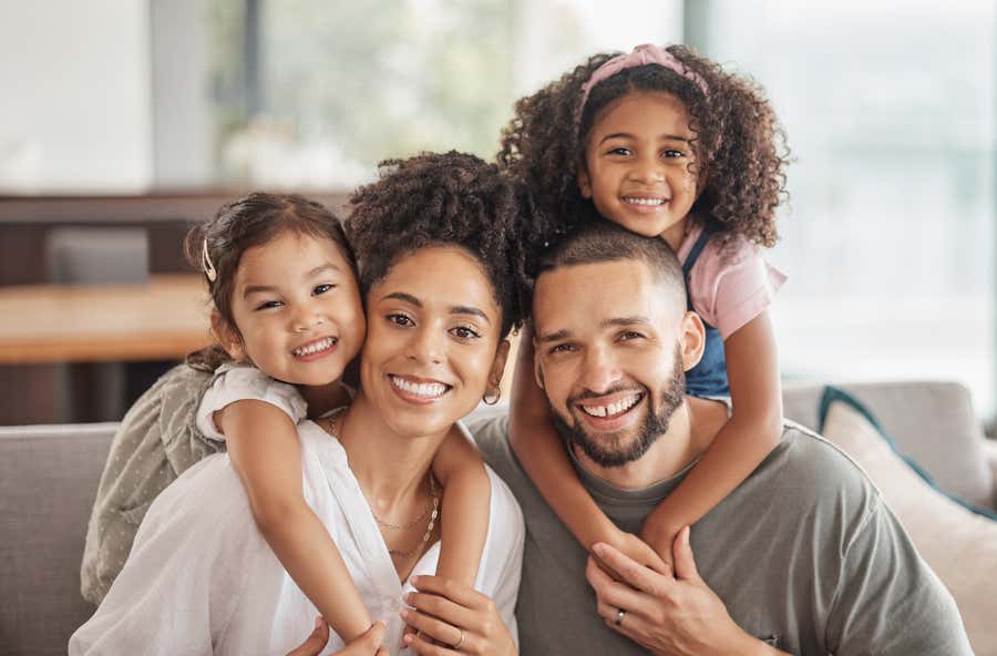 Family of 4 smiling at camera